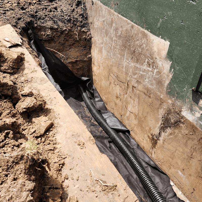 basement perimeter drain being installed