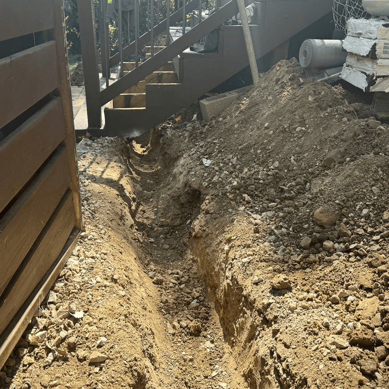 downspout under stairs
