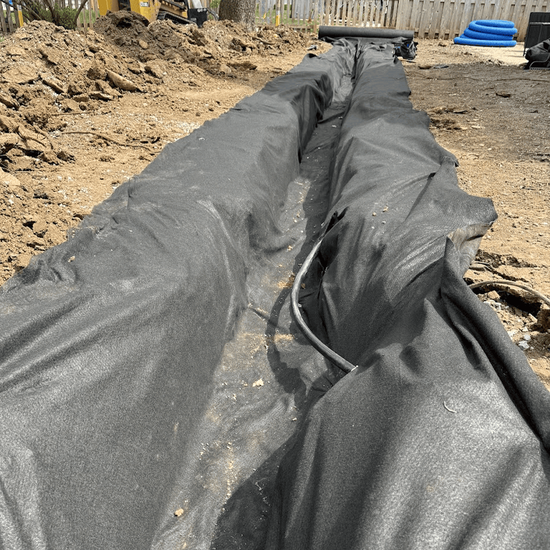 french drain fabric being laid down